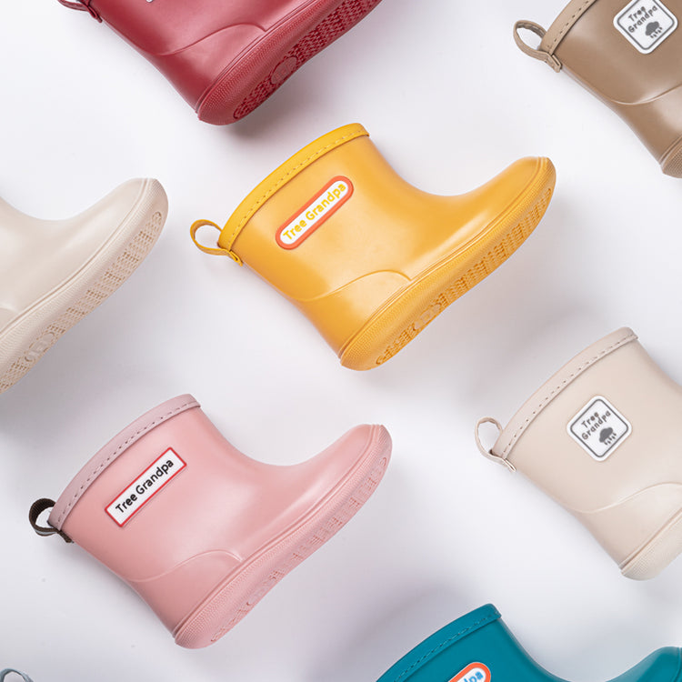 Children’s waterproof rain boots for boys, girls, and infants. Durable rubber boots available in various colors and sizes for wet weather