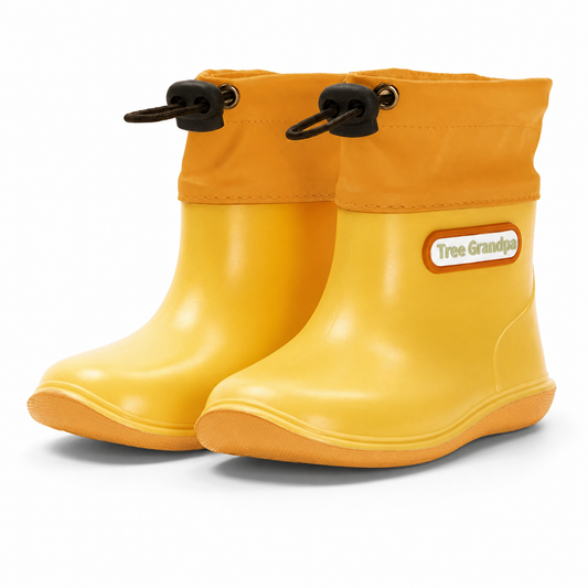 A pair of yellow toddler rain boots with black drawstring loops on the collar and a white 'Tree Grandpa' brand patch on the side, shown against a plain white background.